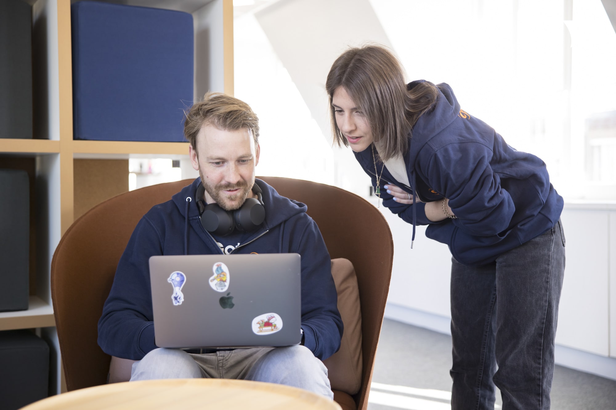 A businessman showing his laptop screen to his colleague